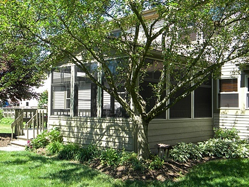 Beige PGT Eze Breeze windows installed by APCO into an existing screened room.