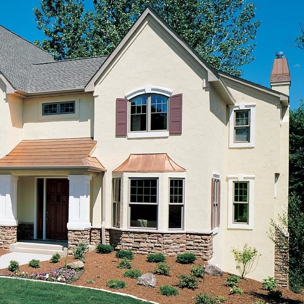 Fiberglass double hung windows with grids enhance the colonial styling of this home.
