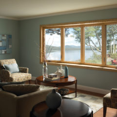 lake house room with new bay windows in blue room with hardwood floors and beige furniture