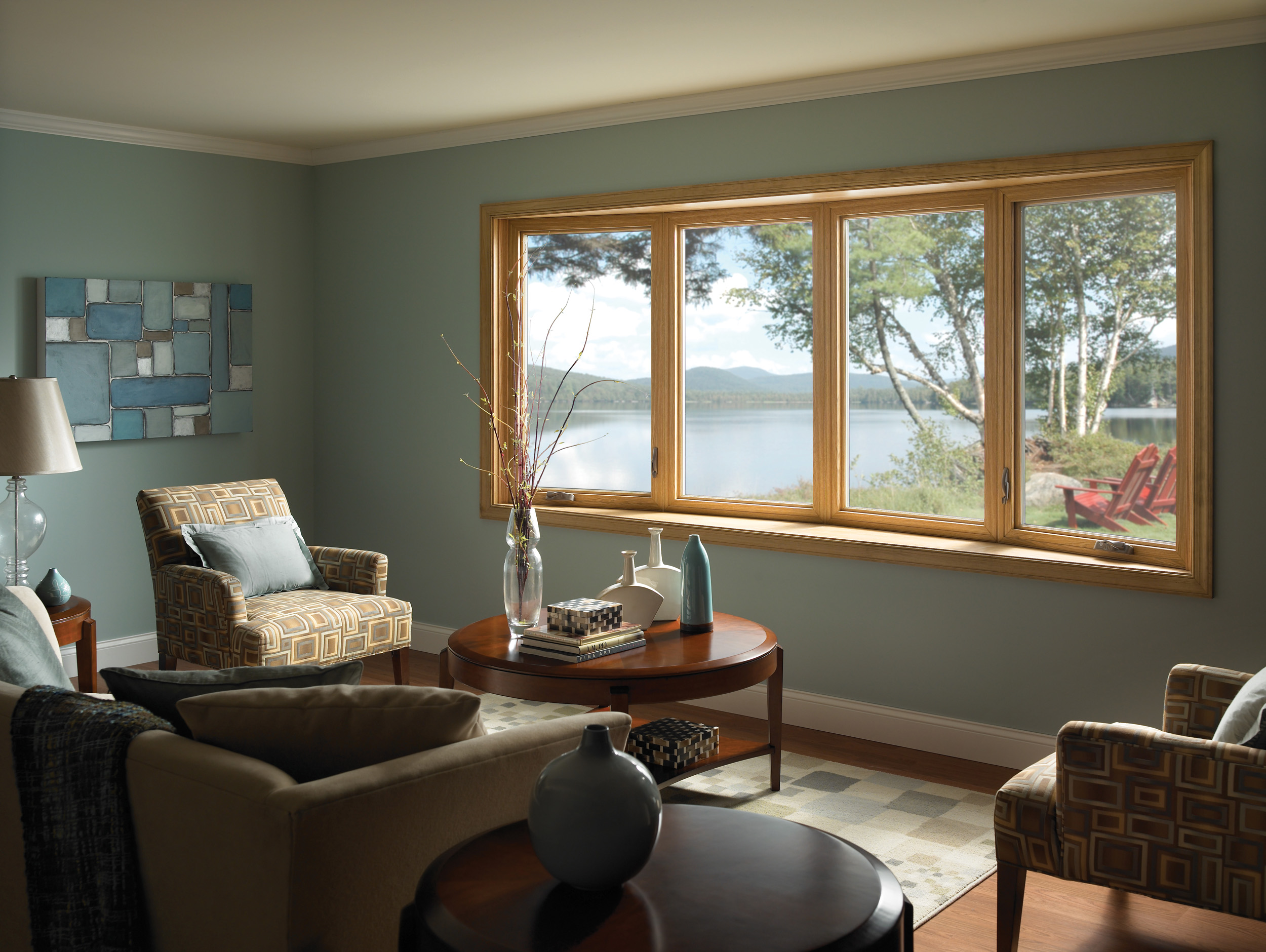 lake house room with new bay windows in blue room with hardwood floors and beige furniture
